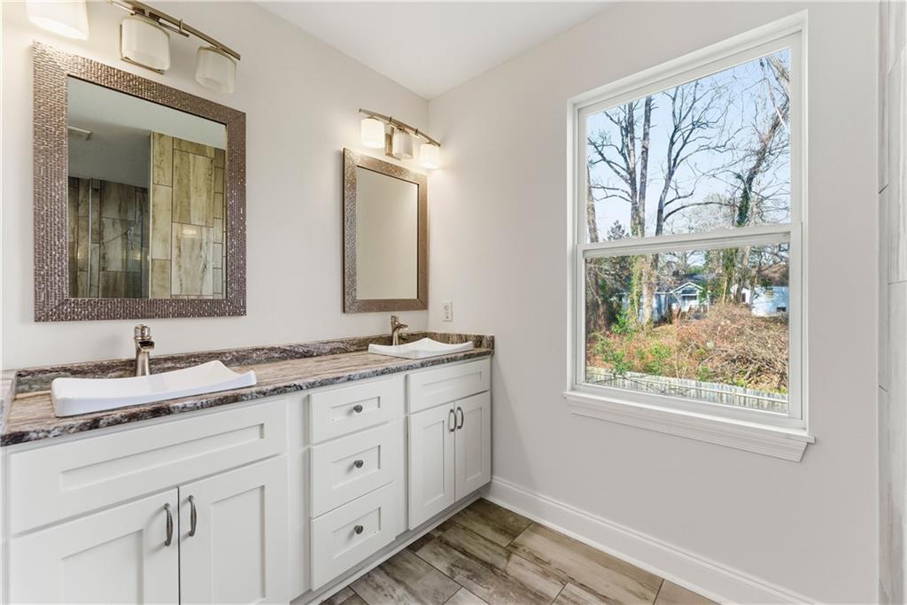 1779 North Olympian Way Southwest Atlanta, GA 30310 - Photo 37 of 48 a bathroom with 2 sink and a mirror