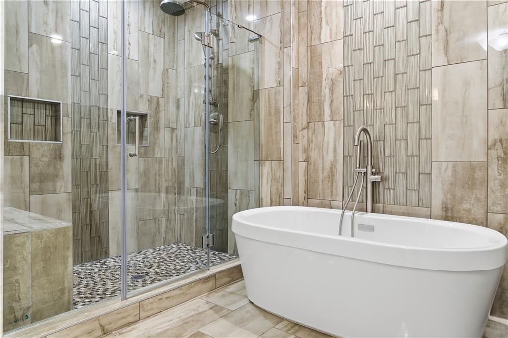 1779 North Olympian Way Southwest Atlanta, GA 30310 - Photo 38 of 48 a bathroom with a bathtub and shower