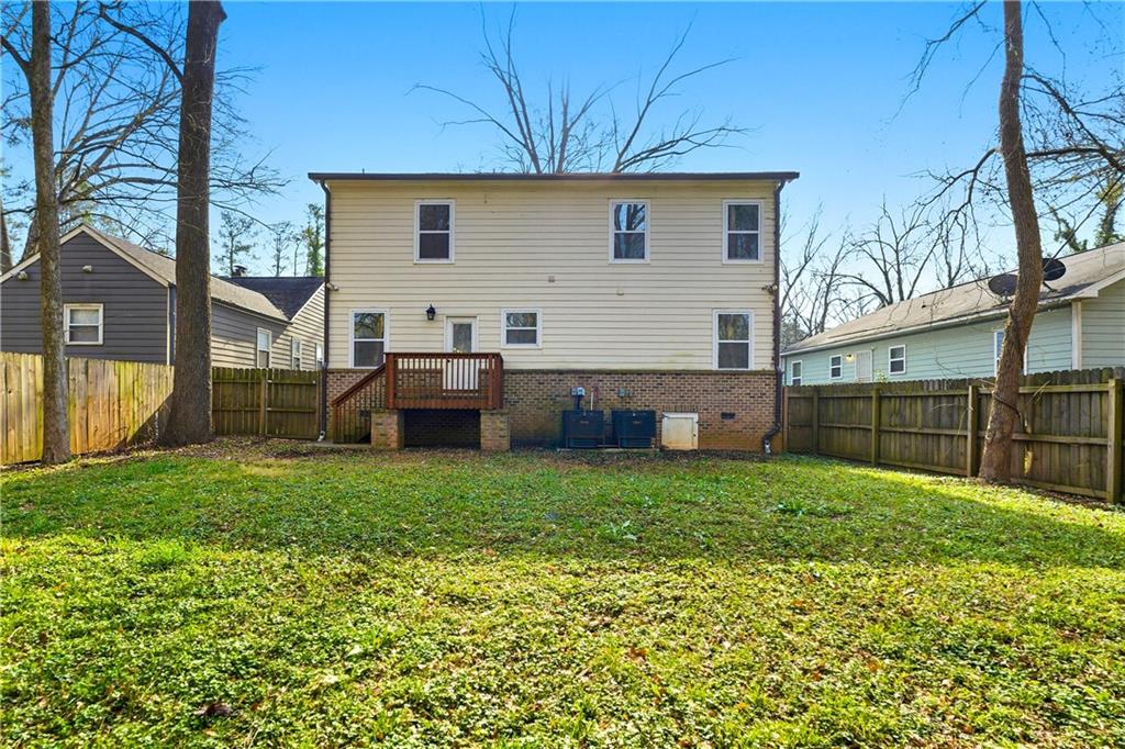 1779 North Olympian Way Southwest Atlanta, GA 30310 - Photo 45 of 48 a backyard of a house with wooden fence and large trees