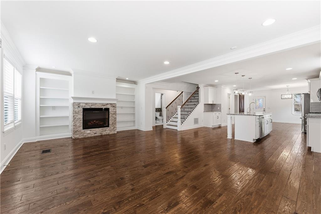1779 North Olympian Way Southwest Atlanta, GA 30310 - Photo 6 of 48 a view of empty room with wooden floor and fireplace