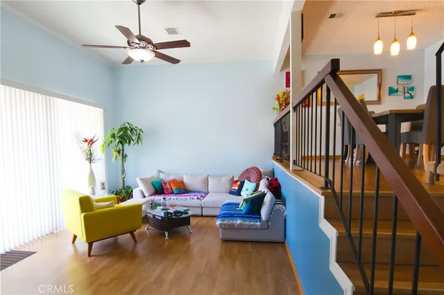 a bedroom with furniture entryway and wooden floor
