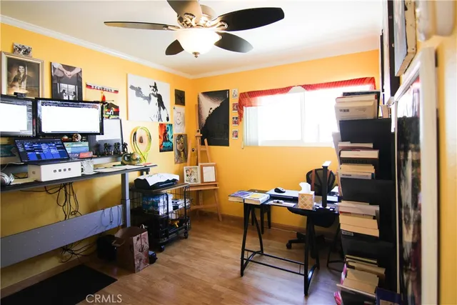 a view of a workspace with furniture and a window