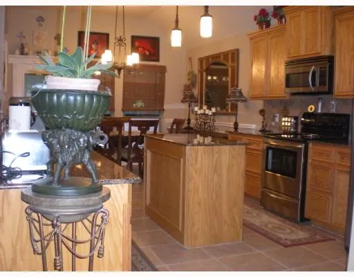 a kitchen with stainless steel appliances granite countertop a sink stove and microwave