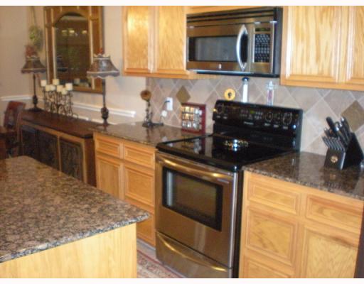 6825 Guinevere Street Corpus Christi, TX 78414 - Photo 6 of 10 a kitchen with stainless steel appliances granite countertop a sink stove and microwave