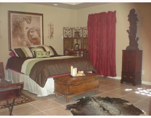 6825 Guinevere Street Corpus Christi, TX 78414 - Photo 8 of 10 a bedroom with a bed and a chandelier