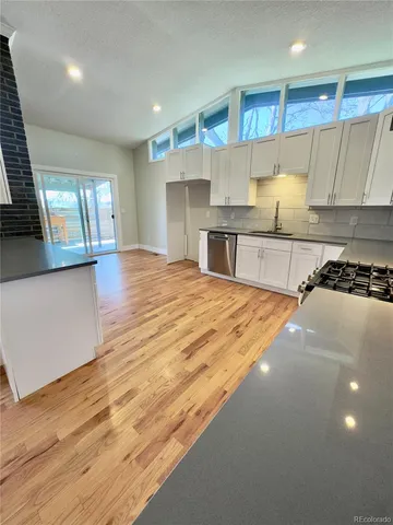 a kitchen with stainless steel appliances granite countertop a sink and cabinets