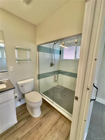 a bathroom with a toilet and a shower