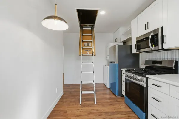 a kitchen with stainless steel appliances granite countertop a stove and a refrigerator