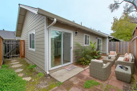 a view of a house with backyard and sitting area