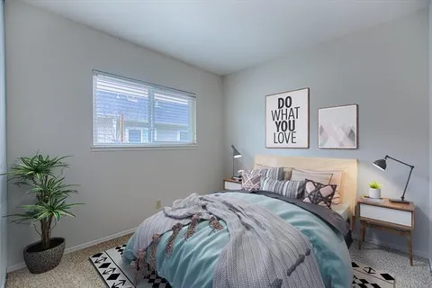 a bedroom with a bed and a couch