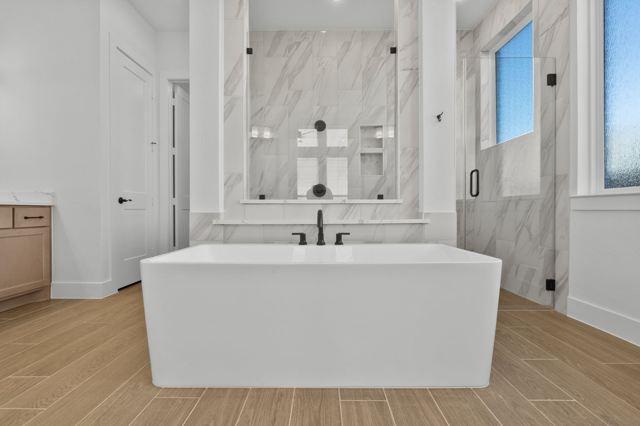 407 Blue River Trail Rosenberg, TX 77471 - Photo 14 of 45 a white bath tub sitting in a bathroom