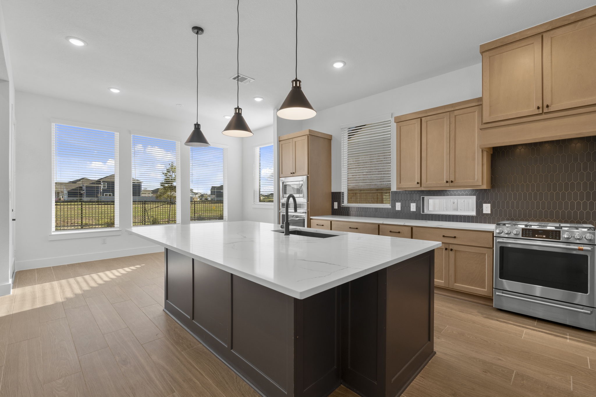 407 Blue River Trail Rosenberg, TX 77471 - Photo 22 of 45 a kitchen with stainless steel appliances granite countertop a sink a stove and a wooden floors