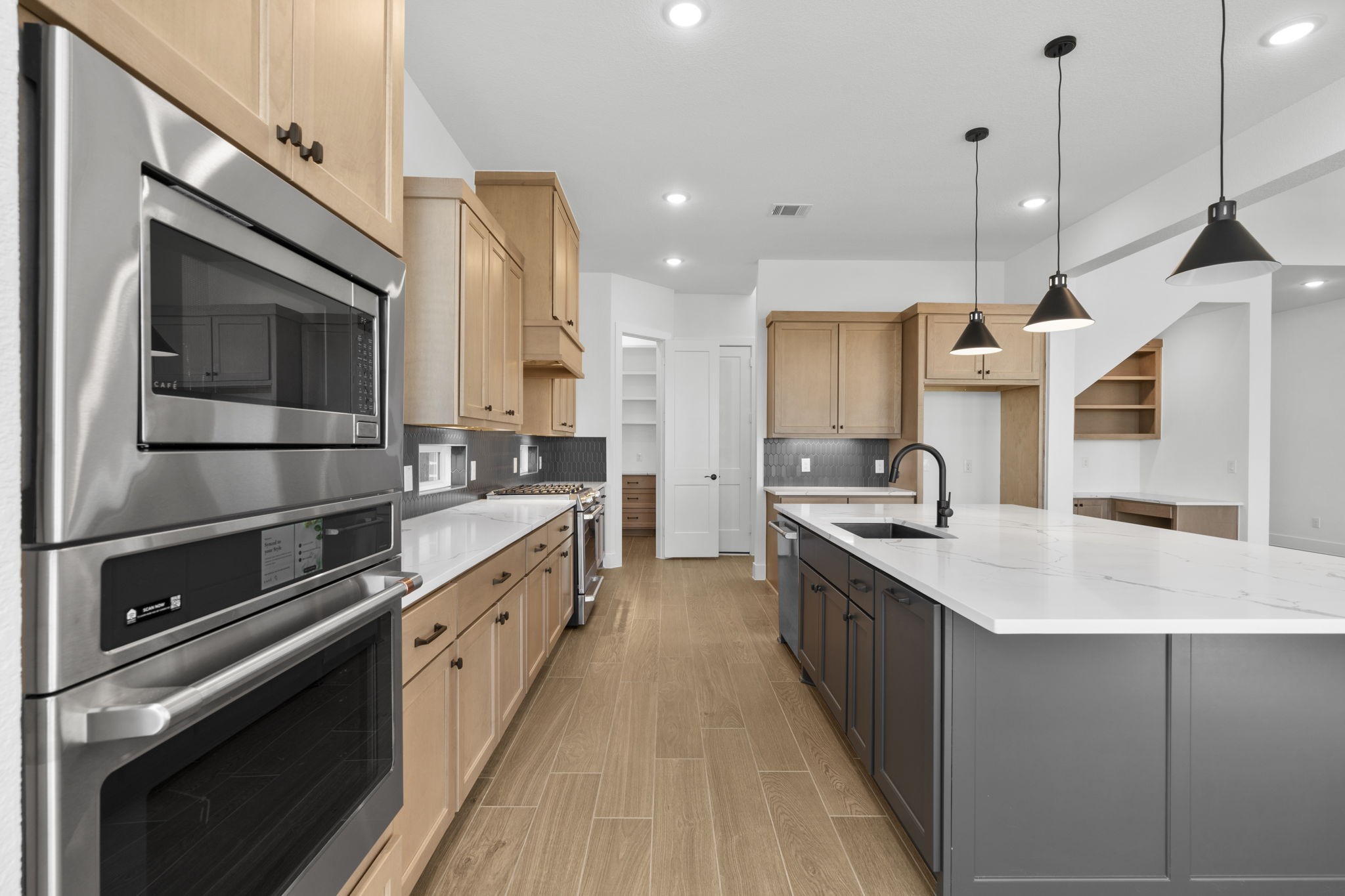 407 Blue River Trail Rosenberg, TX 77471 - Photo 27 of 45 a kitchen with a sink stove and microwave