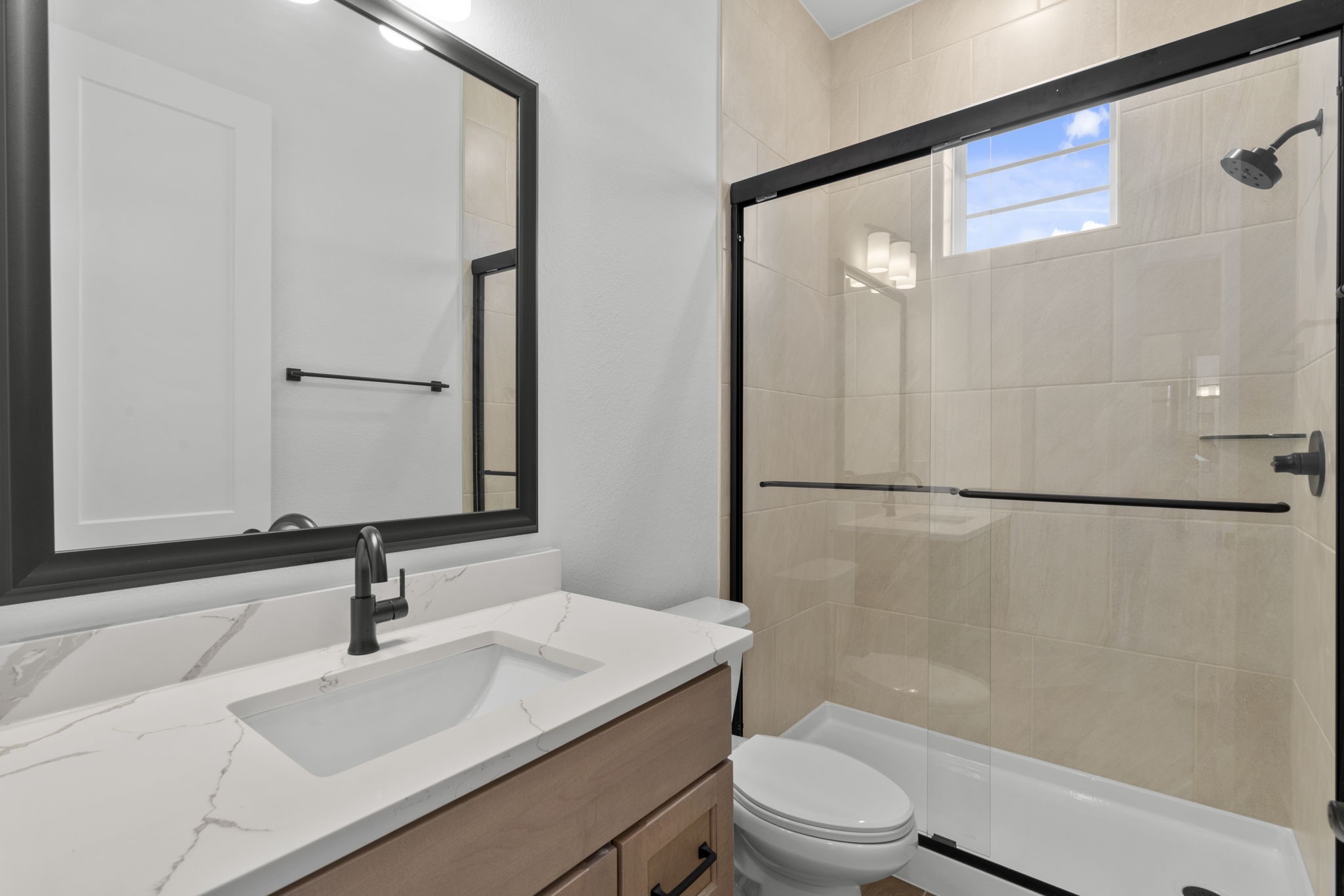 407 Blue River Trail Rosenberg, TX 77471 - Photo 3 of 45 a bathroom with a sink a toilet and a large mirror