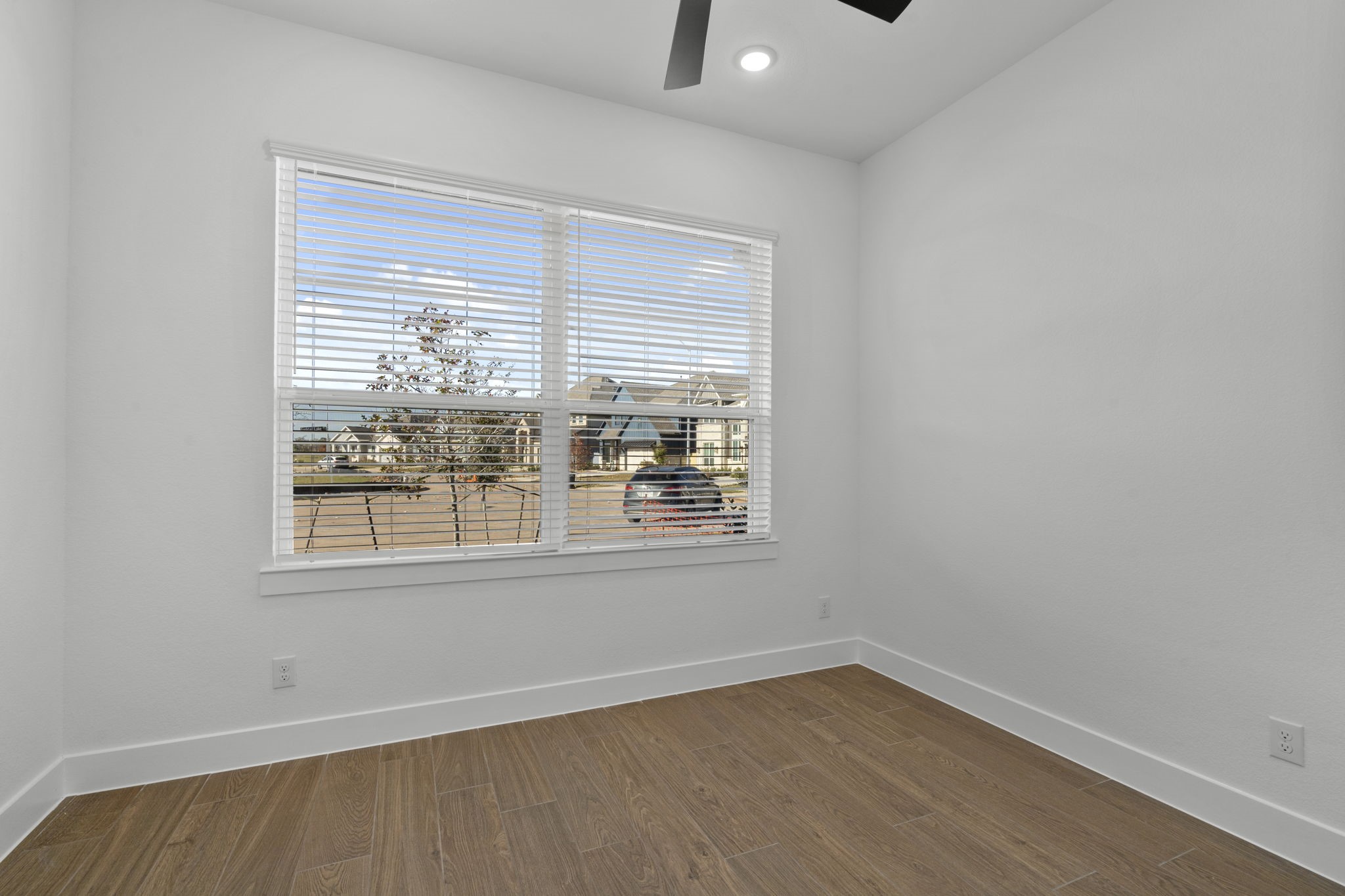 407 Blue River Trail Rosenberg, TX 77471 - Photo 4 of 45 an empty room with wooden floor and windows