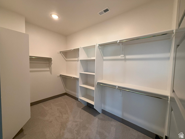 8087 South 615 East, Unit 3 Sandy, UT 84070 - Photo 10 of 23 Expansive walk-in closet featuring built-in shelving, multiple hanging rods, and recessed ceiling lighting