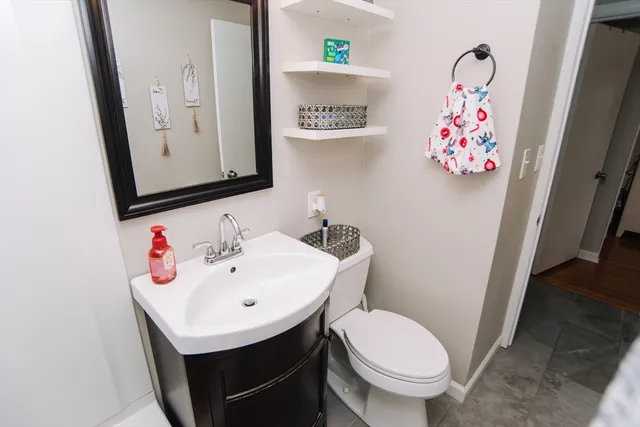 a bathroom with a sink mirror and toilet
