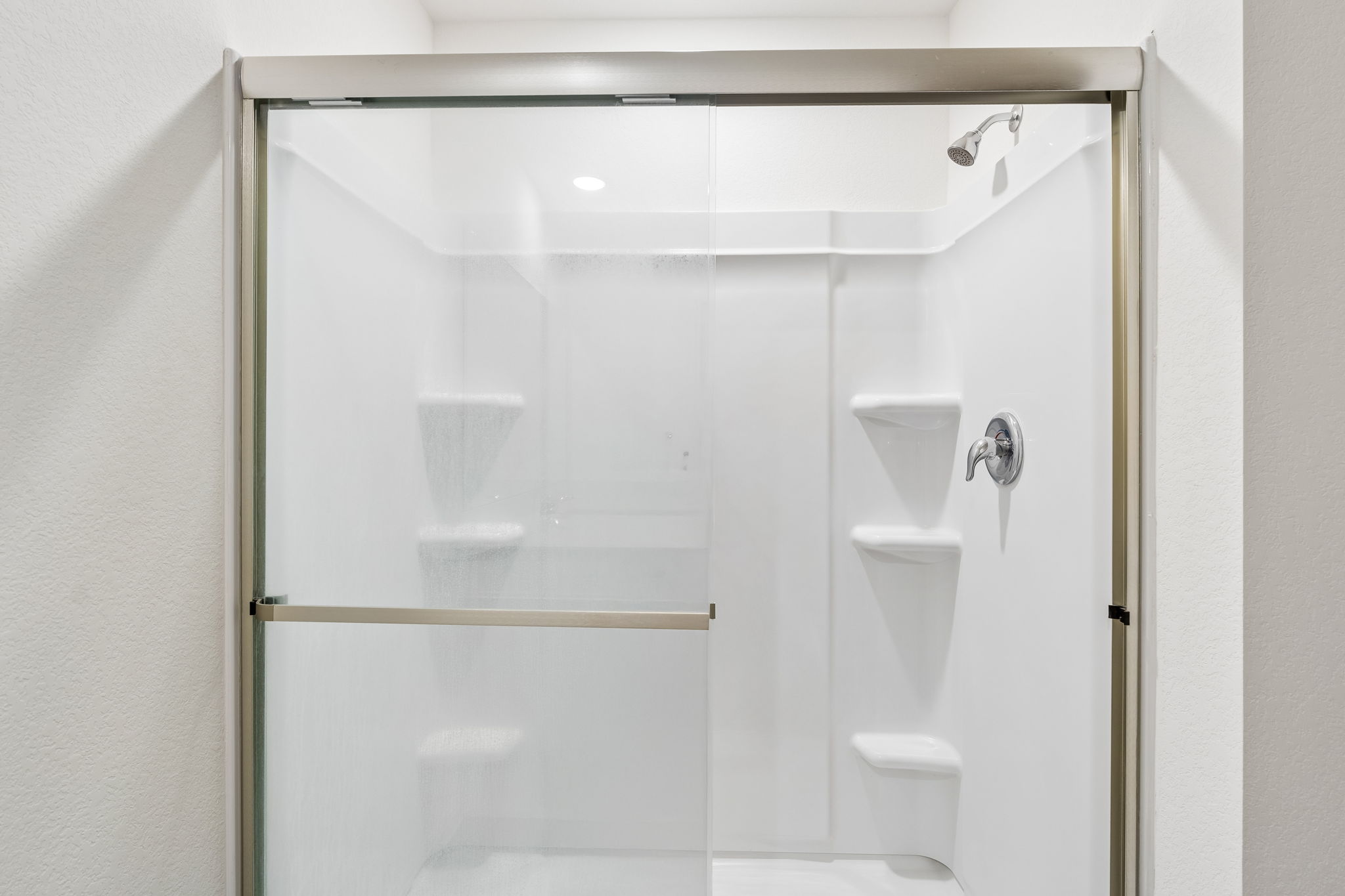 550 Thistle Lane Maxwell, TX 78656 - Photo 18 of 29 Bathroom with a shower stall and a textured wall