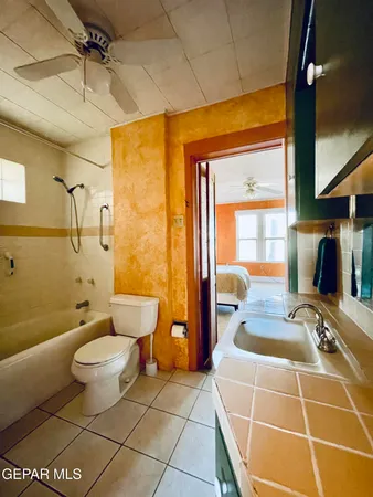 a bathroom with a toilet a sink and shower