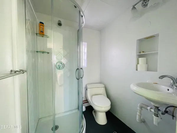 a bathroom with a sink toilet and shower
