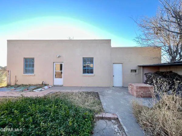 a backyard of a house with table and chairs