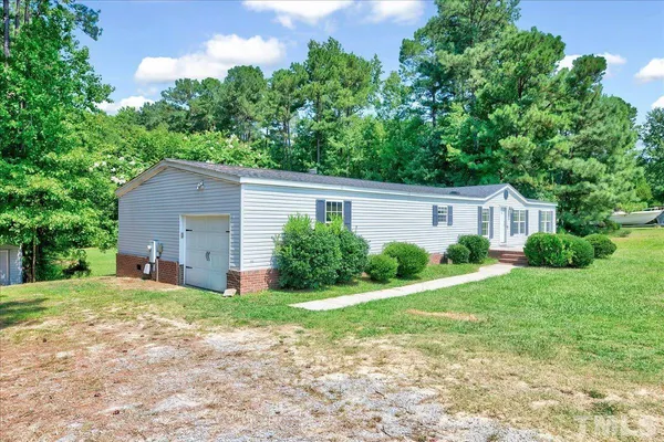a view of a house with a yard and plants