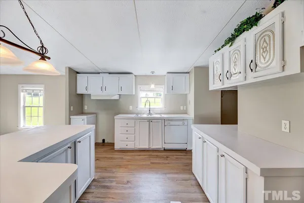 a kitchen with a stove a sink and a refrigerator