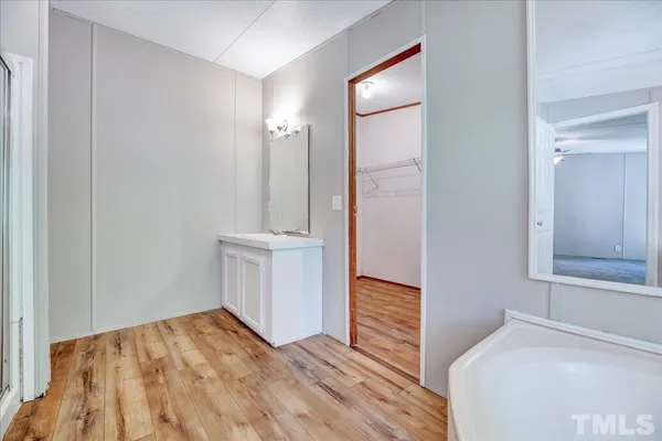 a view of empty room with wooden floor