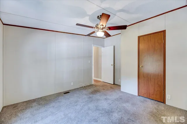 a view of a room with a ceiling fan