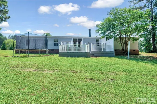 a view of a house with a yard and pathway