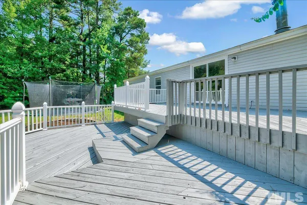 a view of a deck with wooden floor and fence
