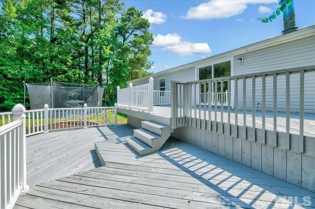 a view of a deck with wooden floor and fence