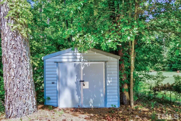 a wooden door with trees in the background