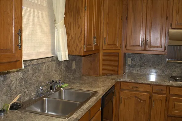 a kitchen with granite countertop a sink and a window