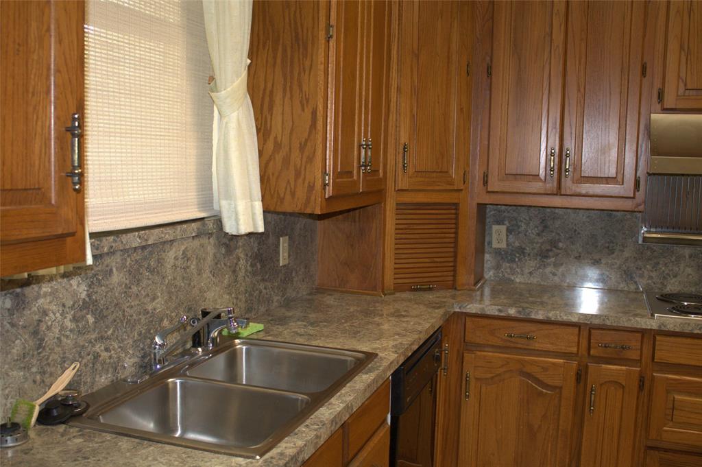 2300 West Main Street Lancaster, TX 75146 - Photo 12 of 22 a kitchen with granite countertop a sink and a window