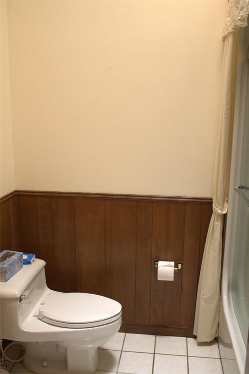 2300 West Main Street Lancaster, TX 75146 - Photo 14 of 22 a toilet sitting in a bathroom next to a sink