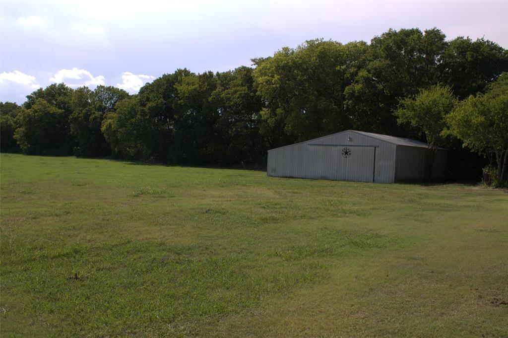 2300 West Main Street Lancaster, TX 75146 - Photo 4 of 22 a view of a big yard with a large tree