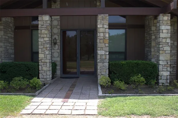a view of a brick house with a yard