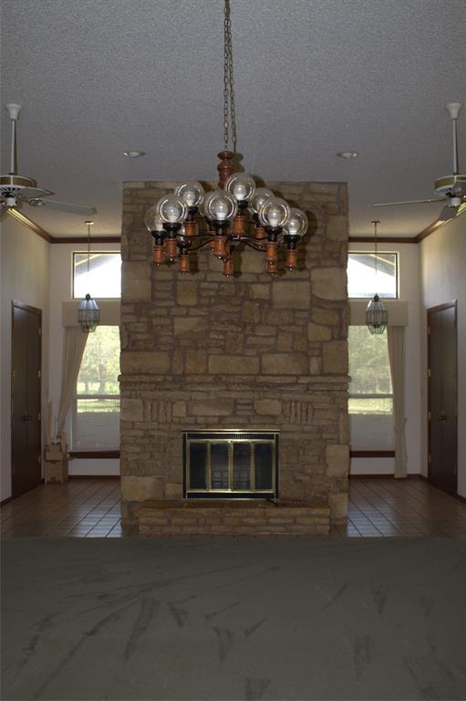 2300 West Main Street Lancaster, TX 75146 - Photo 9 of 22 a room with fireplace and chandelier