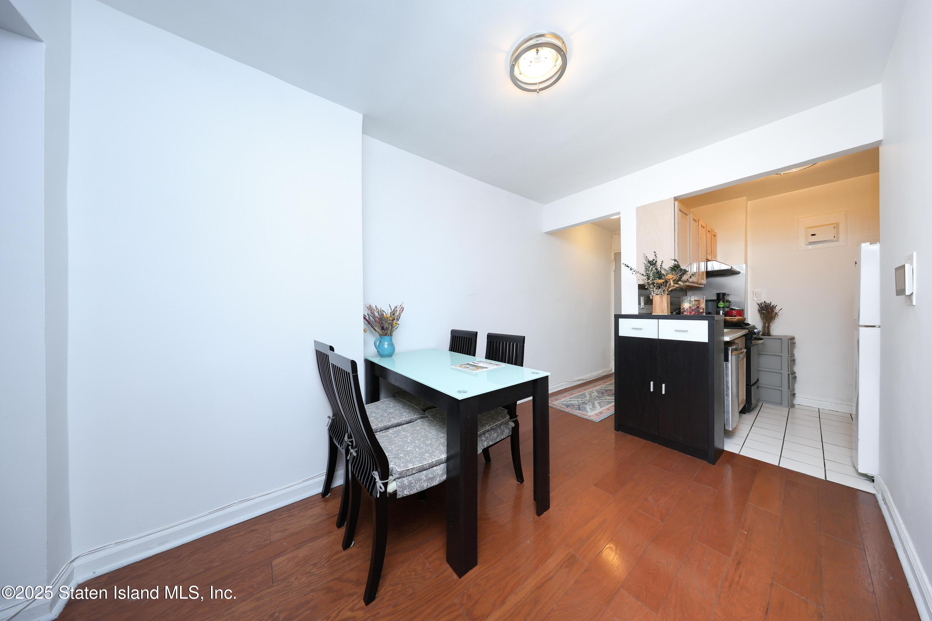 9040 Fort Hamilton Parkway, Unit 6C Brooklyn, NY 11209 - Photo 12 of 18 a kitchen with a table and chairs in it