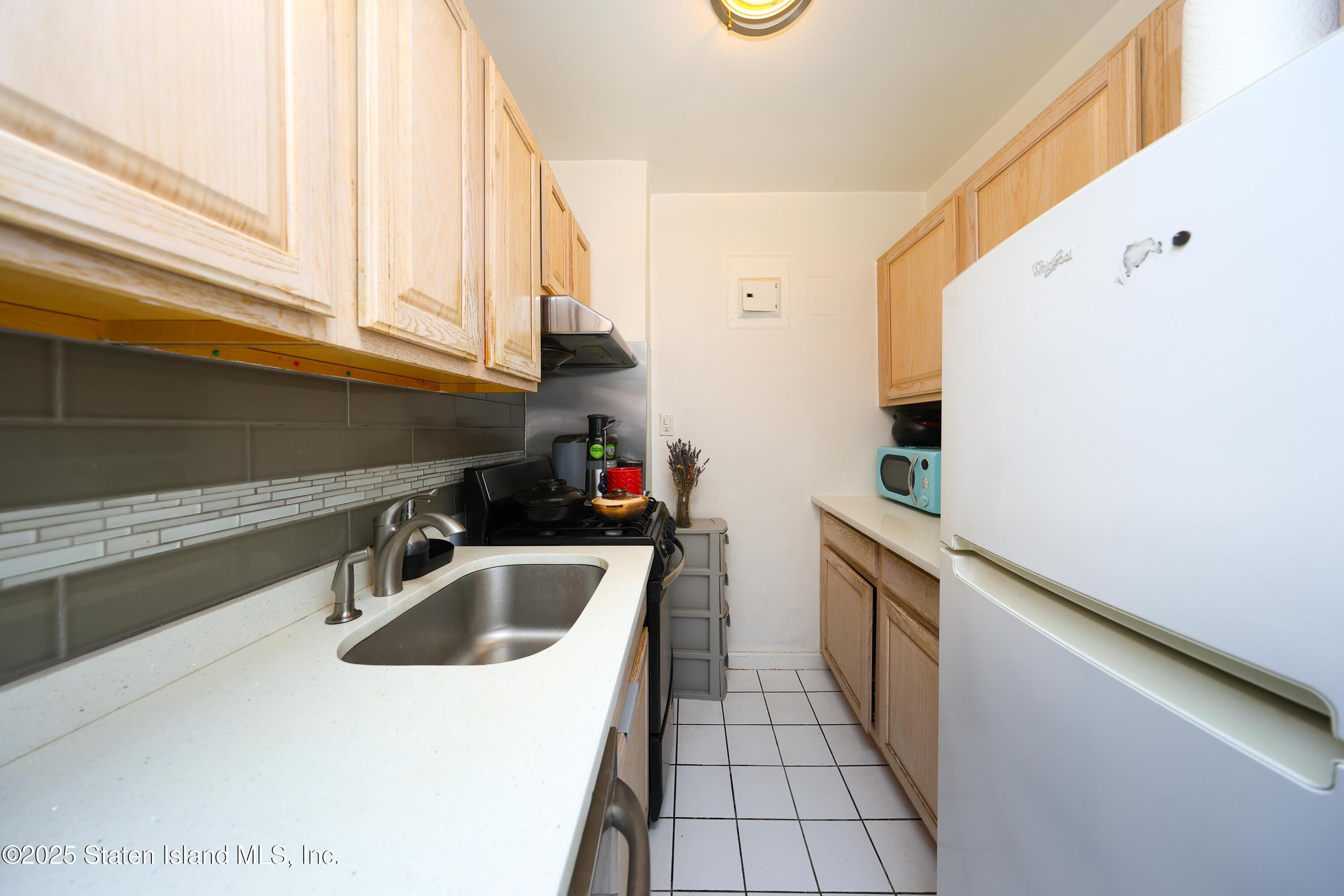 9040 Fort Hamilton Parkway, Unit 6C Brooklyn, NY 11209 - Photo 13 of 18 a kitchen that has a sink and a stove