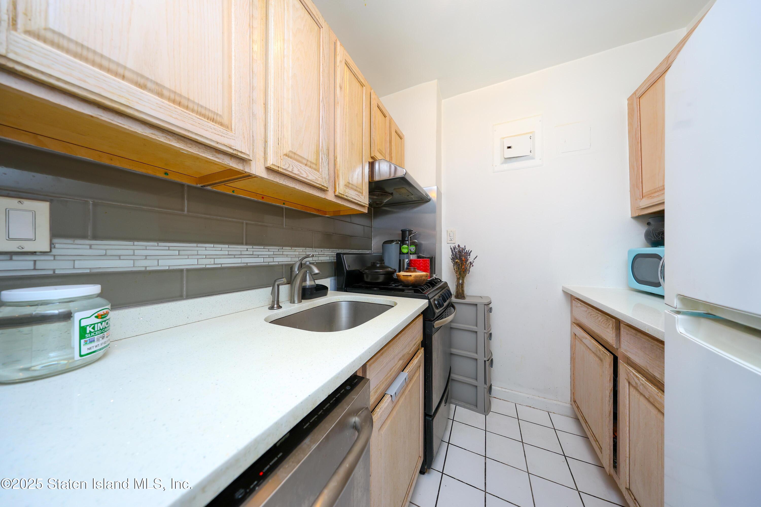 9040 Fort Hamilton Parkway, Unit 6C Brooklyn, NY 11209 - Photo 14 of 18 a kitchen with a sink and cabinets