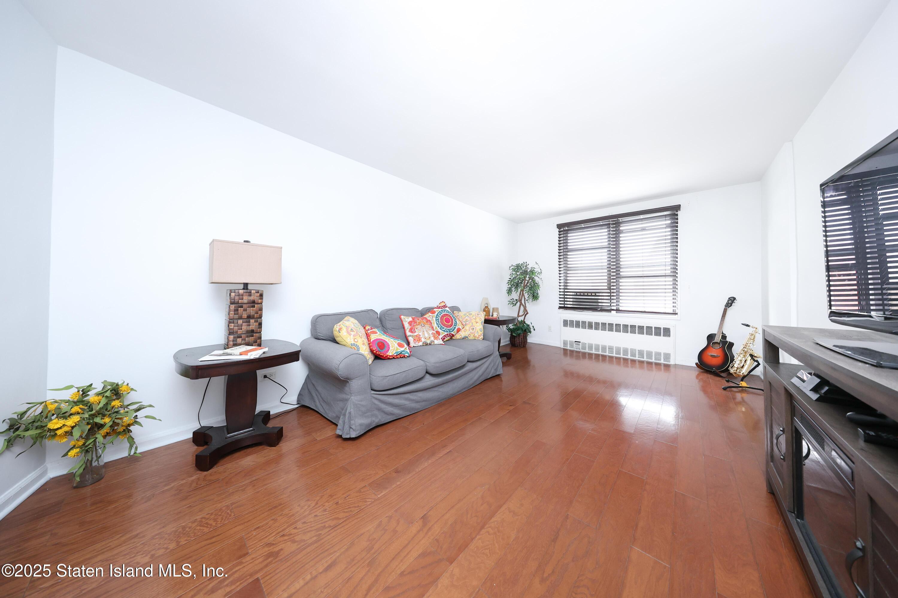 9040 Fort Hamilton Parkway, Unit 6C Brooklyn, NY 11209 - Photo 7 of 18 a living room with furniture and a wooden floor