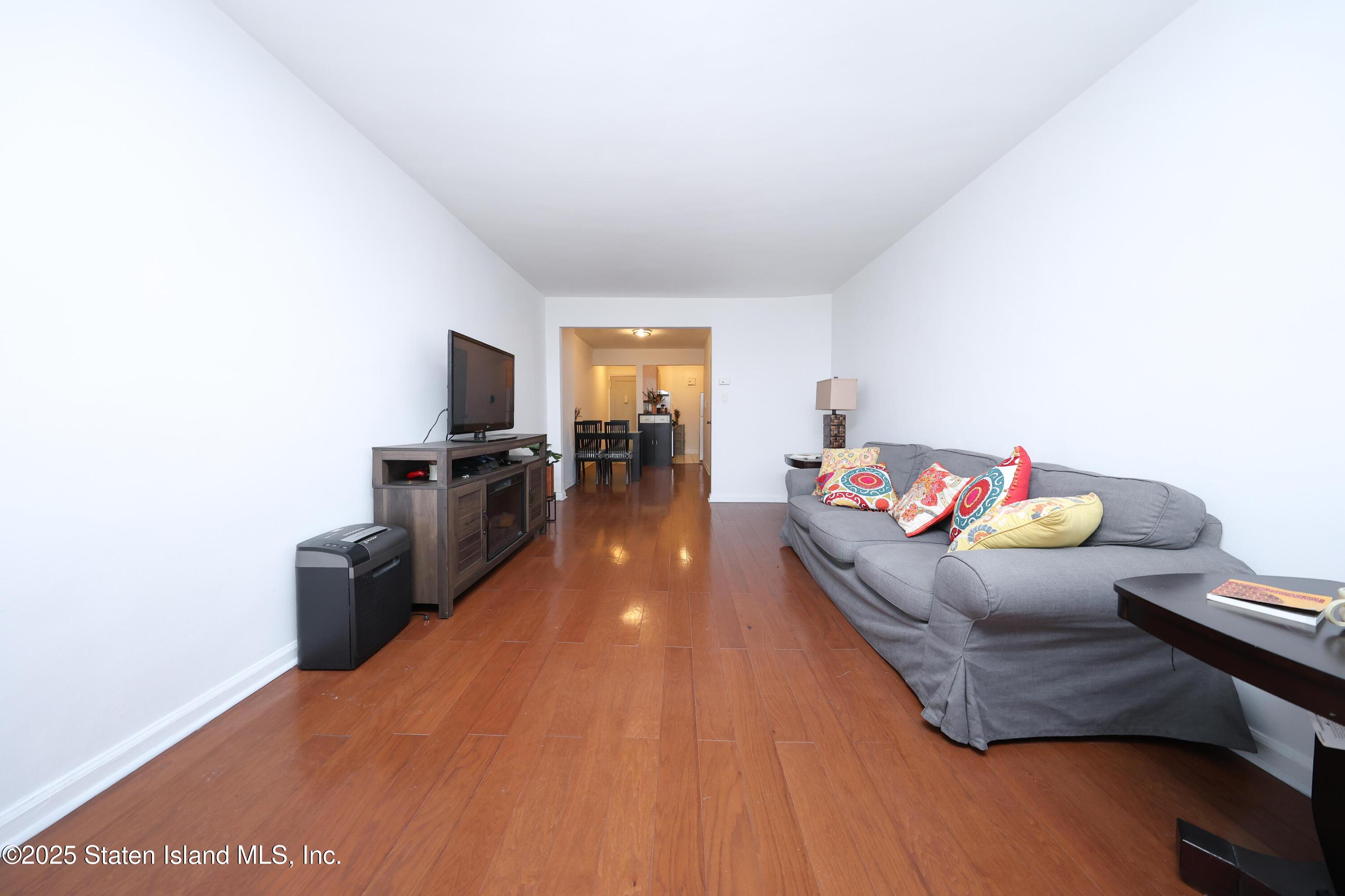 9040 Fort Hamilton Parkway, Unit 6C Brooklyn, NY 11209 - Photo 8 of 18 a living room with furniture and a wooden floor