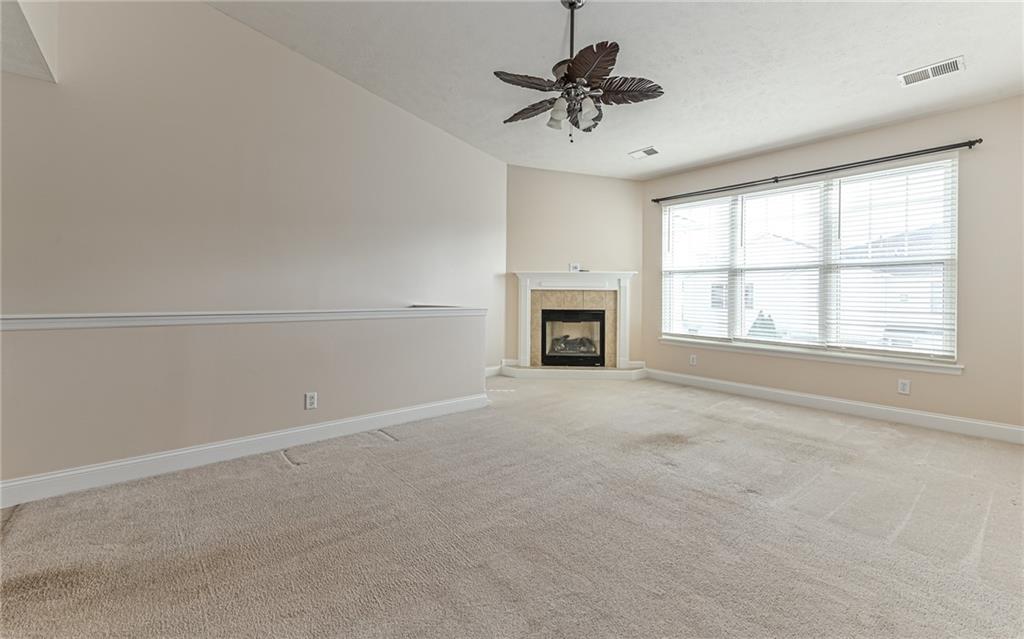 227 Adams Pointe Boulevard, Unit 3 Mars, PA 16046 - Photo 11 of 16 a view of an empty room with a fireplace and a window