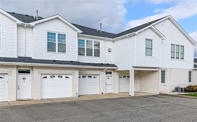 a front view of a house with a garage