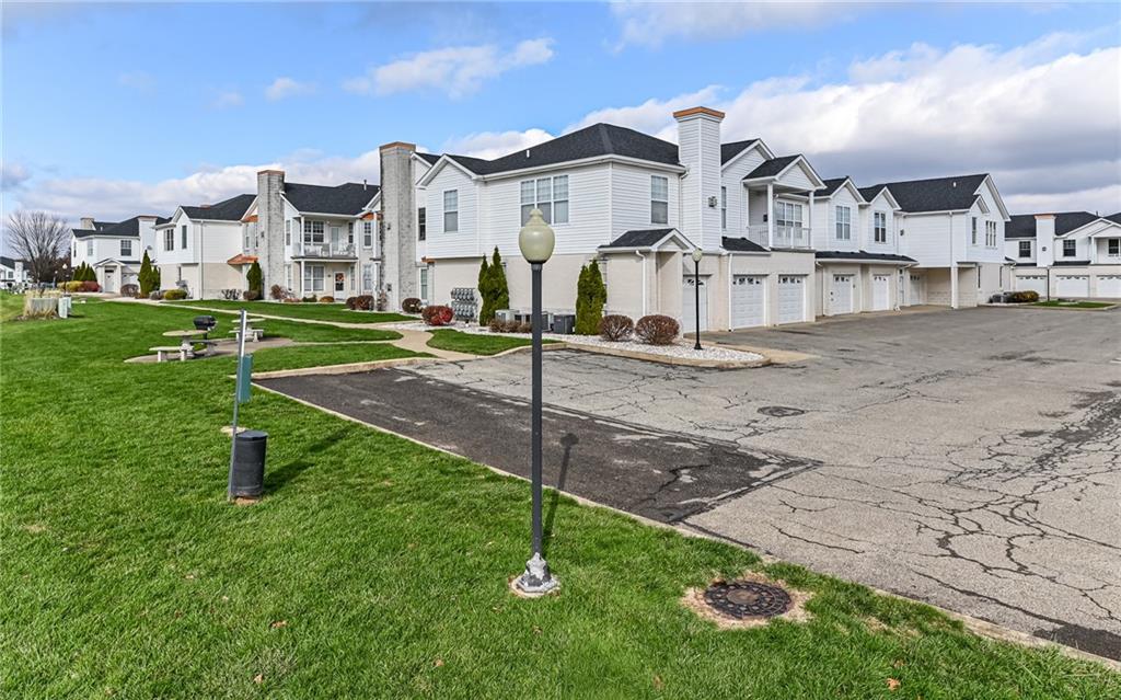 227 Adams Pointe Boulevard, Unit 3 Mars, PA 16046 - Photo 15 of 16 a view of a house with a yard
