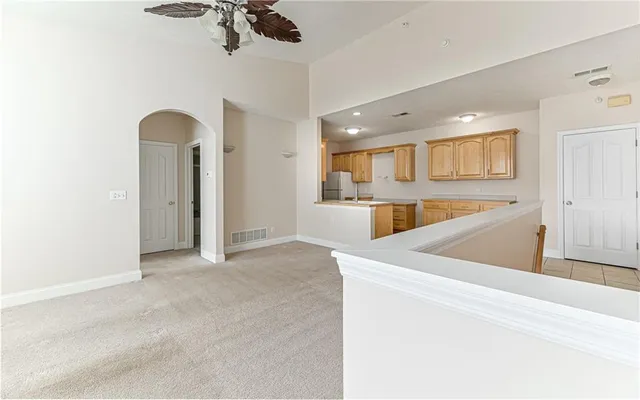 a view of kitchen with refrigerator and microwave