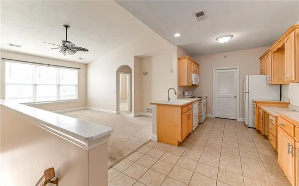 a kitchen with stainless steel appliances granite countertop a sink and a stove