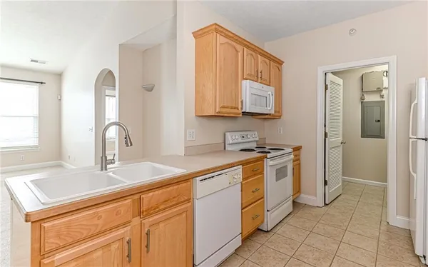 a kitchen with stainless steel appliances granite countertop a sink and cabinets